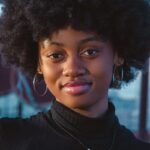 a close up of a person with an afro