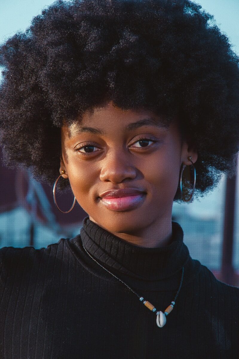 a close up of a person with an afro